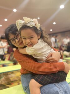 Joykids teacher hugging preschool child at JoyKids International Preschool, Bandar Utama